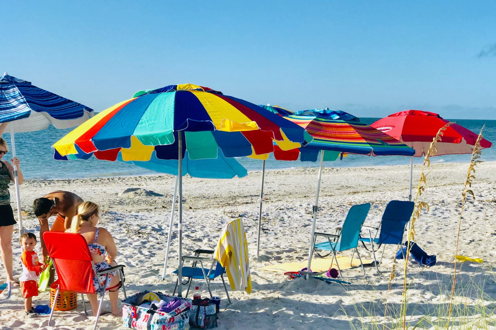 Friends sitting on sanibel island beach